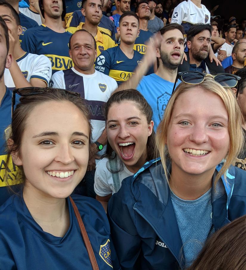 Alana at a football match in the crowd with Boca fans