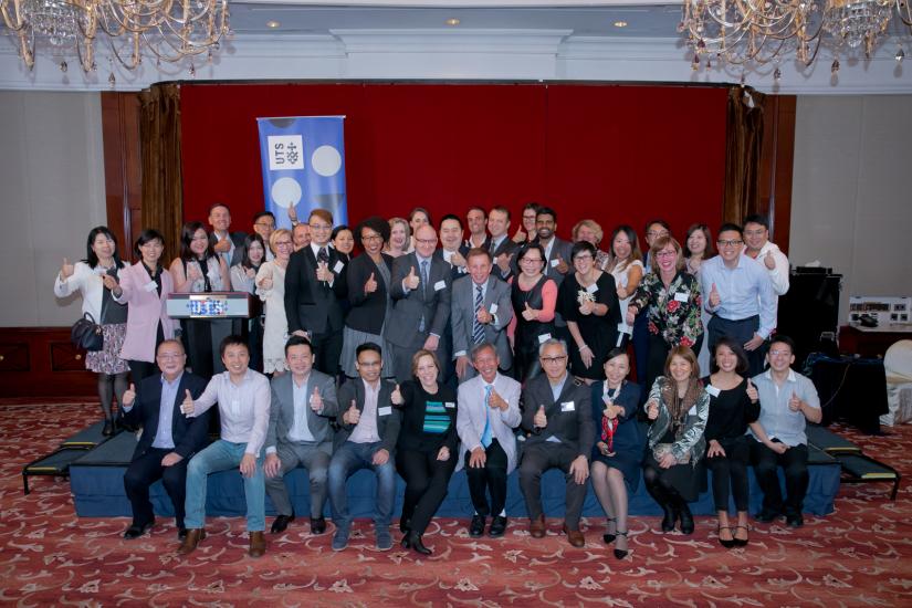 Attendees of the 2018 Hong Kong Alumni reception giving a thumbs up to the camera