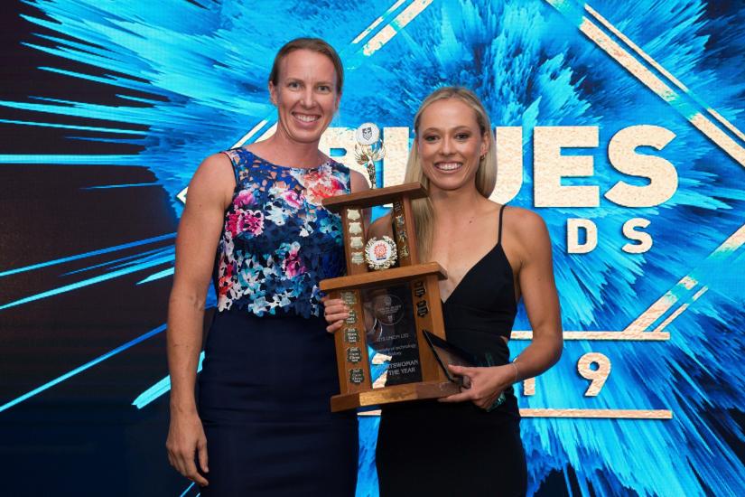 Former Sportswoman of the Year, Jo Brigden-Jones, presents Gabriella O’Grady with the Sportwoman of the Year award. They are both wearing formal wear and smiling at the camera