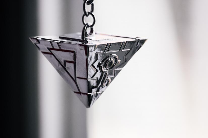 Image of pyramid jewllery with an eye on it in greyscale