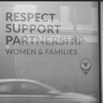 Shot of a window with the words 'respect, support, partnership' in a decal
