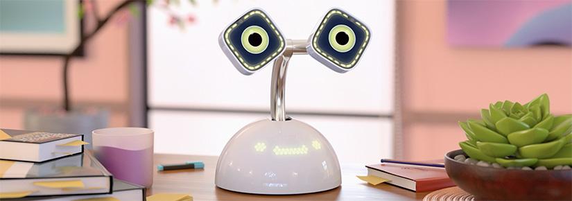A white desktop robot with animated green eyes