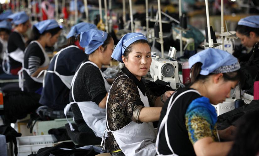 Women sew in a line at a textile factory in Vietnam