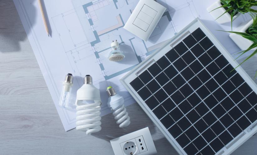 An aerial view of a desk with light bulbs and a solar panel on it