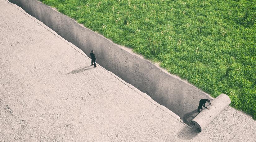Image of man standing on a precipice, the grass is greener on the other side