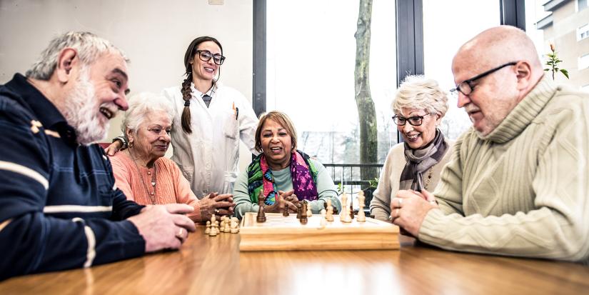 Group of elderly friends playing chess