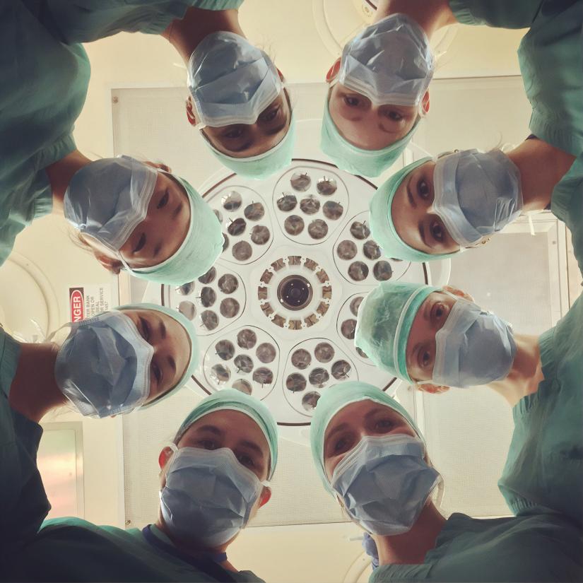 Hospital staff in circular formation looking to camera