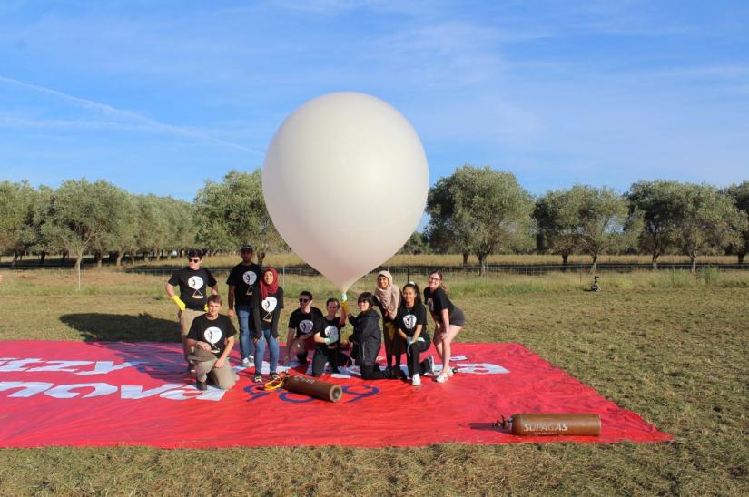 Team posing with the weather balloon