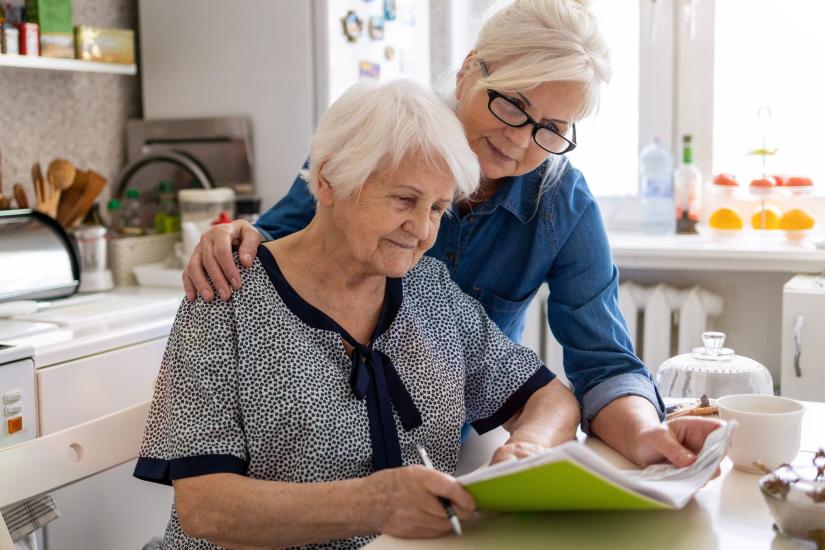 Elderly woman and daughter look at aged care options