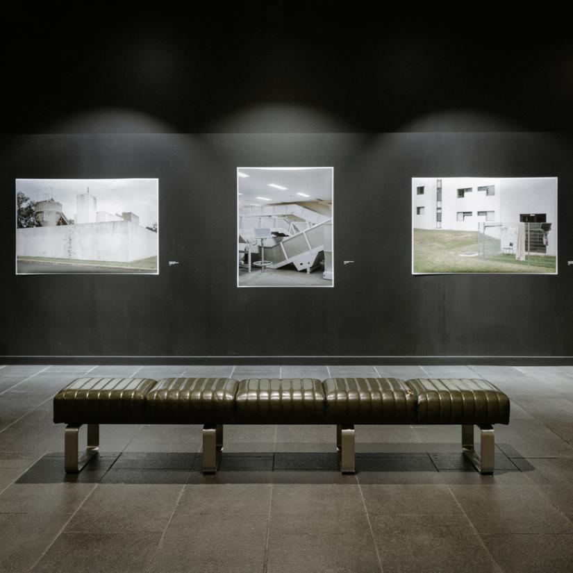 A green leather bench, three unframed photographs