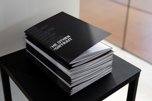 A stack of exhibition catalogues with the title 'The Other Portrait"