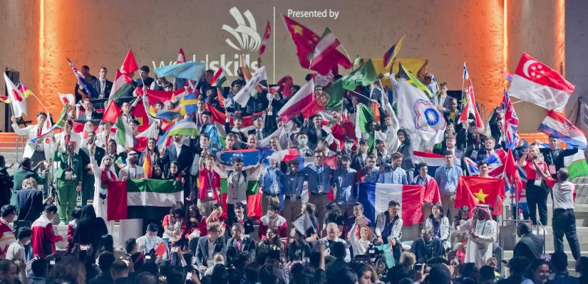 Hundreds of flag-waving competitors pose for photo at WorldSkills 2022