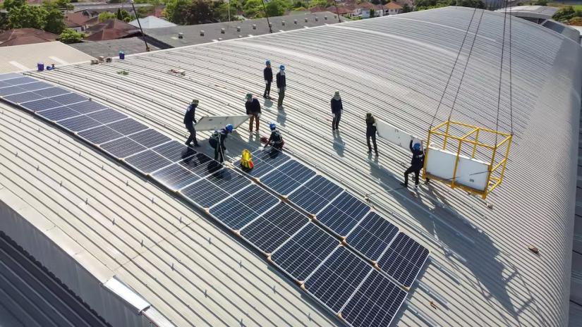 Energy workers installing solar panels