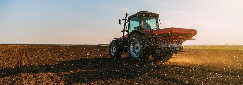Stock picture of a tractor applying fertiliser to a field