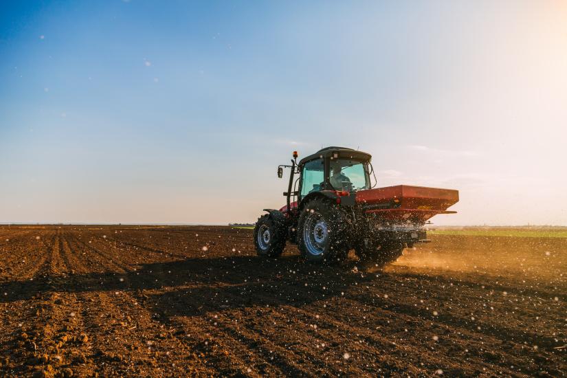 Stock picture of a tractor applying fertiliser to a field