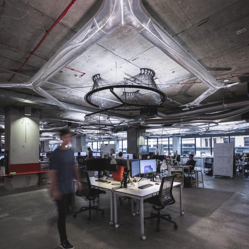 Interior busy office with 3d printed air ducting on ceiling
