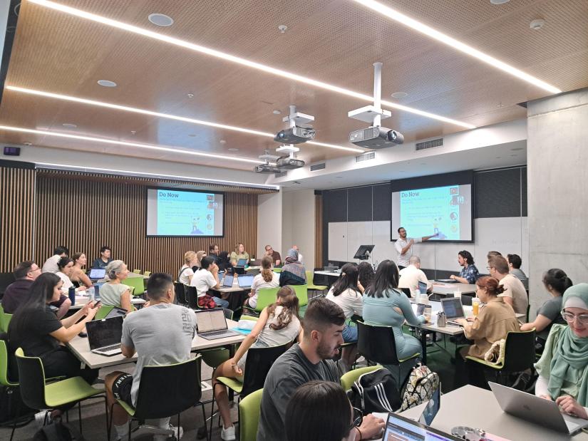 image of UTS students in a classroom being taught by a man standing at the front of the room in front of screen