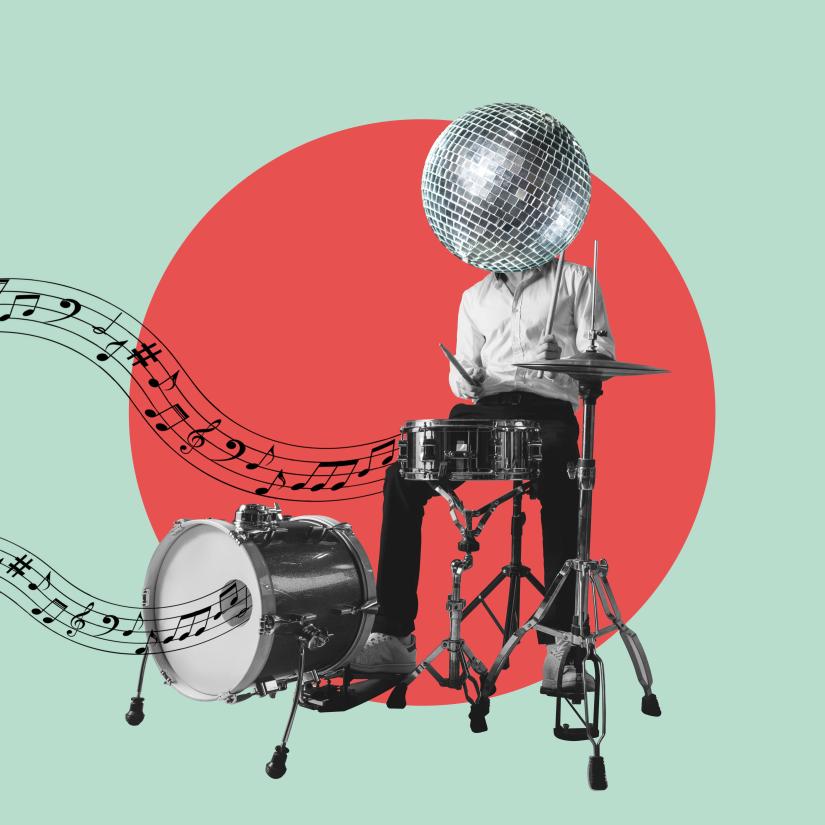 A man drumming on a drumkit with a head that's a disco ball