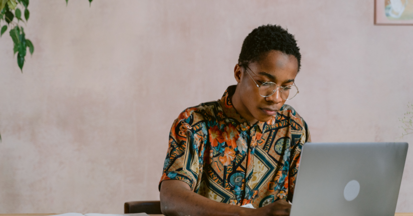 Person studying on laptop wearing a colourful shirt