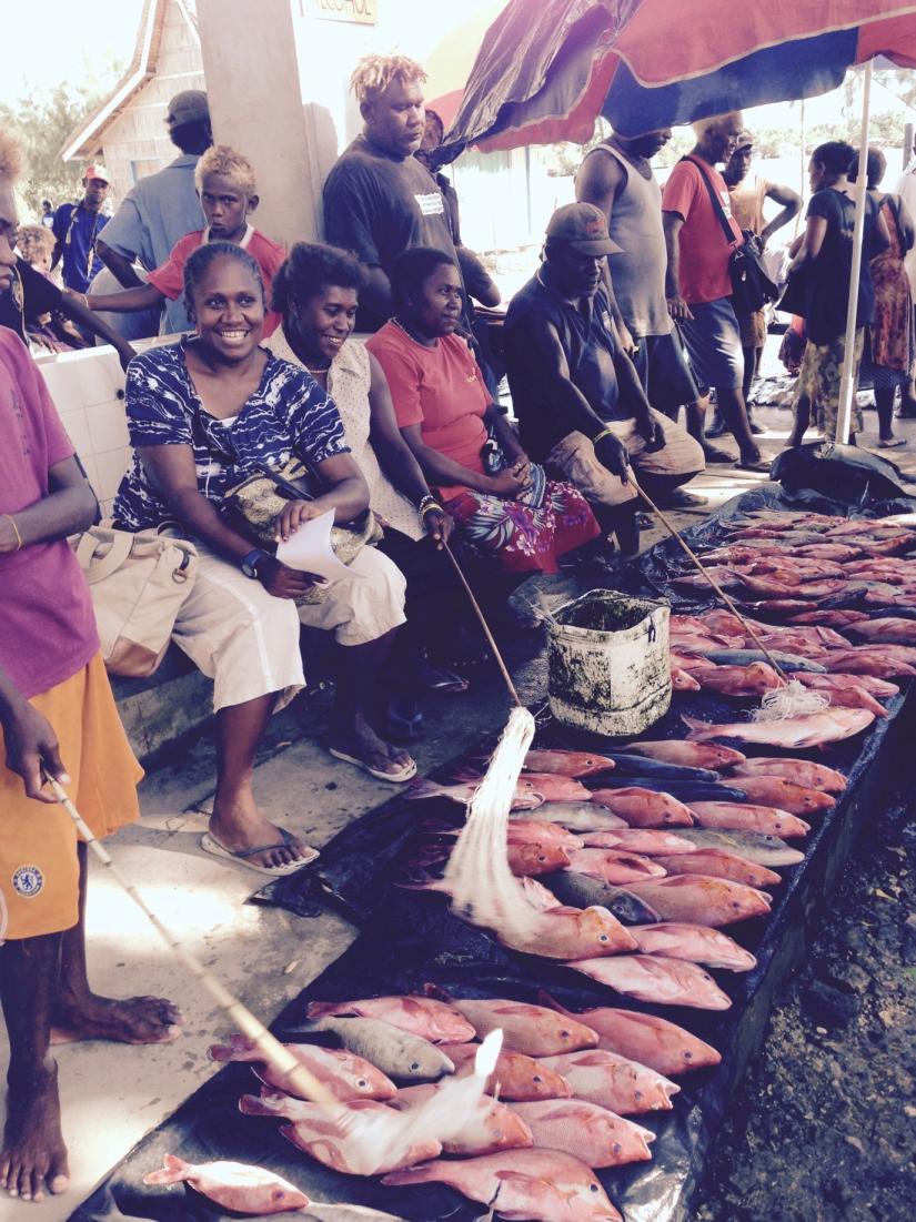 several people cooking fish