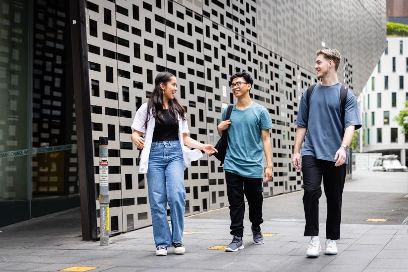 Three students walking outside of UTS Building 11.