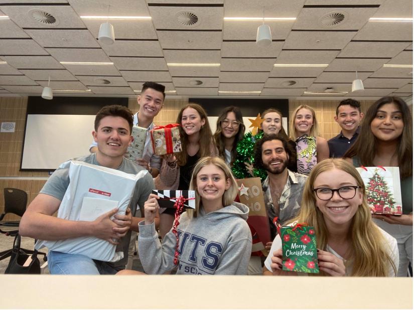 Classmates pose with Christmas decorations