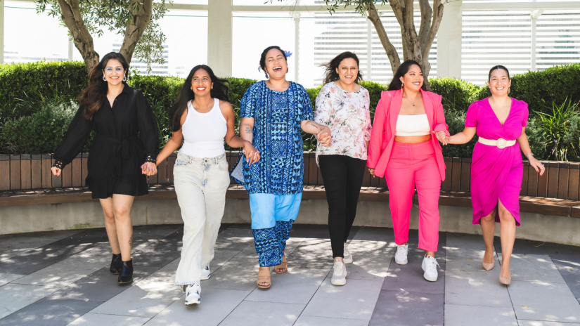 Six multicultural women running and laughing