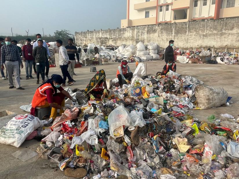 Woman sorting through plastic in India