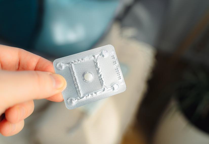 Person holding an Emergency Contraception pill