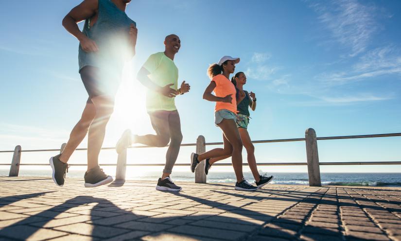 running by the beach. Adobe Stock.