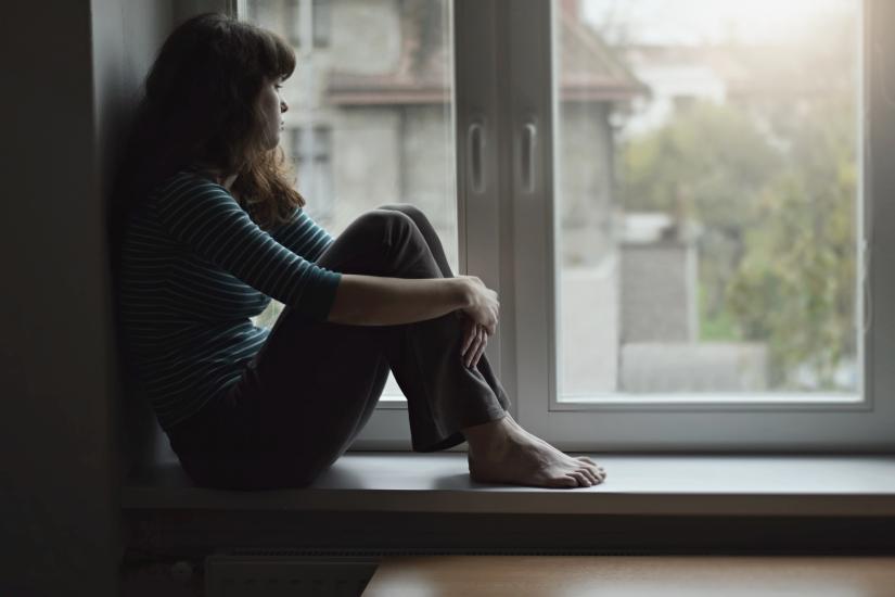 Girl by window in lockdown. Adobe Stock By Tunatura