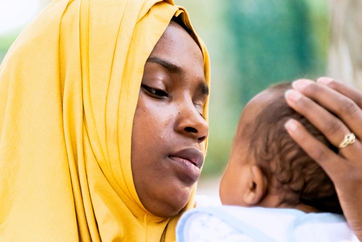 Muslim mother holding her baby