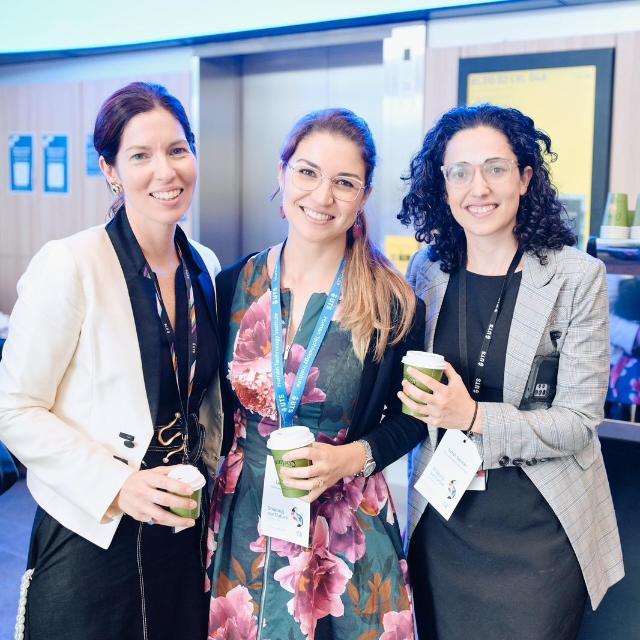 Three women posing for photo, smiling