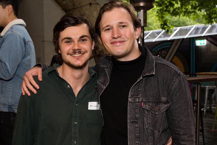 Two men smiling and looking at the camera