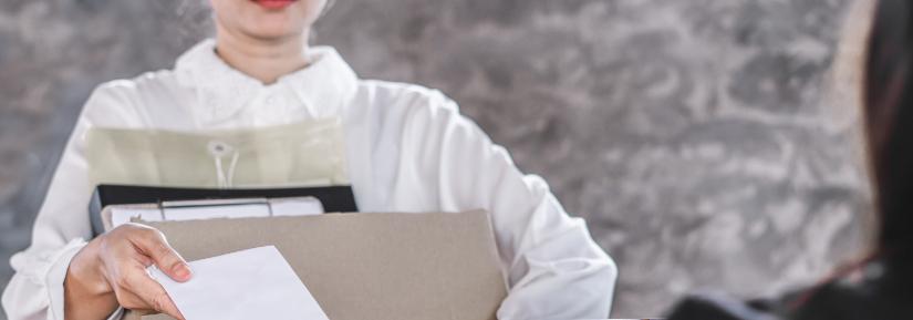 Woman handing in resignation letter