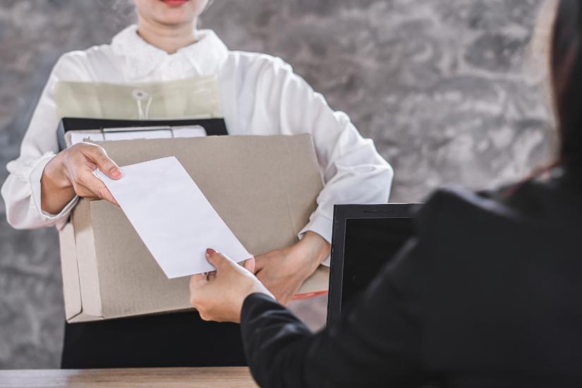 Woman handing in resignation letter