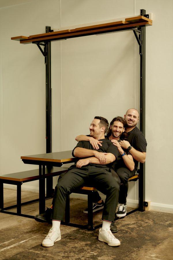 Robert, Henry, Alessandro sitting on their patent-pending TWOFLD furniture, 2022