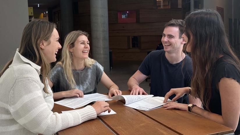 Holly Rewell, Abigail Woods, Matt Neilson and Keily Ting sitting at an outside table working together on the Piping Hot project