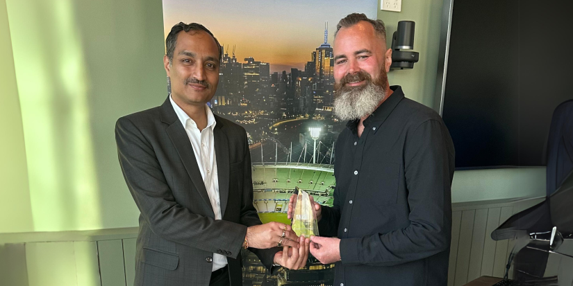 Associate Professor Nabin Sharma and John McRae, Managing Director of VADR Media, holding award at the ceremony.