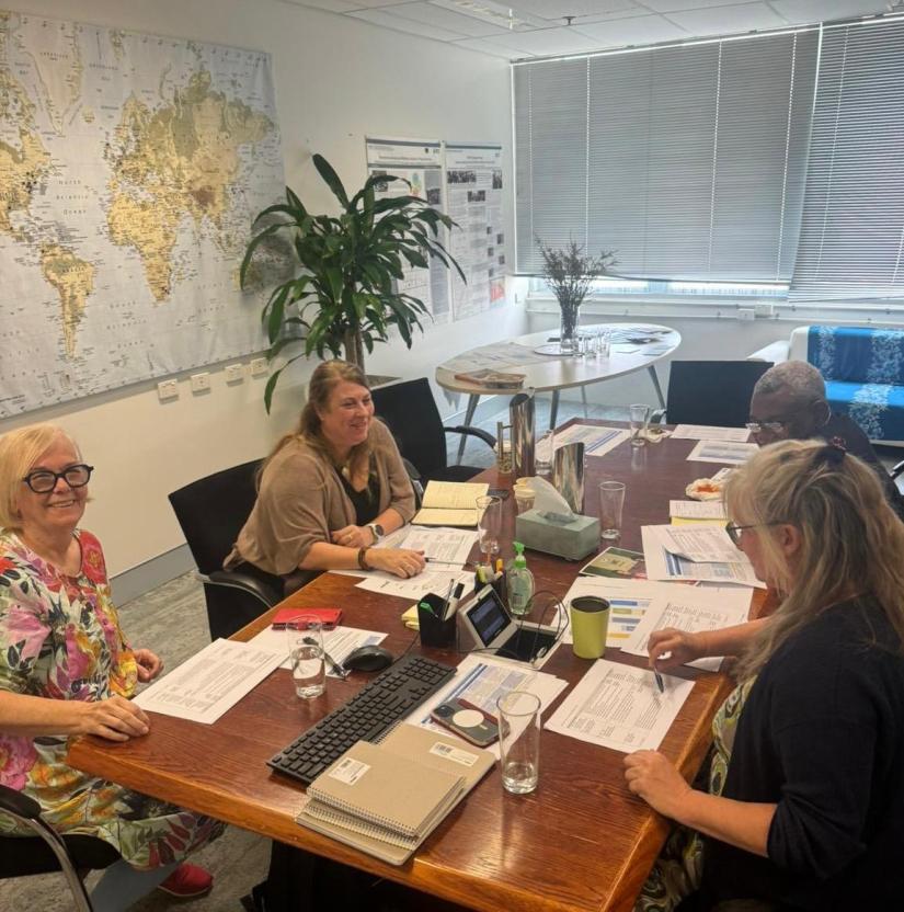 Four people around a table at the PHR Workshop