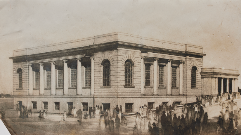 Old sepia toned photograph of building with horses and people in front of it. 