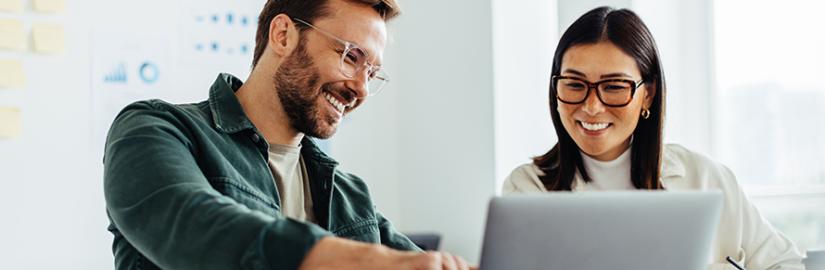 Photo of two people using a computer