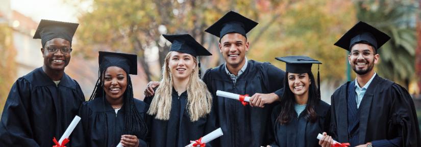 six students in graduation gowns