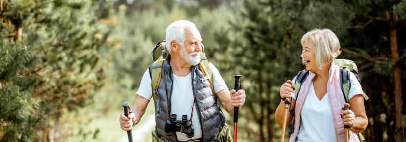 retirees hiking in the woods. Adobe Stock