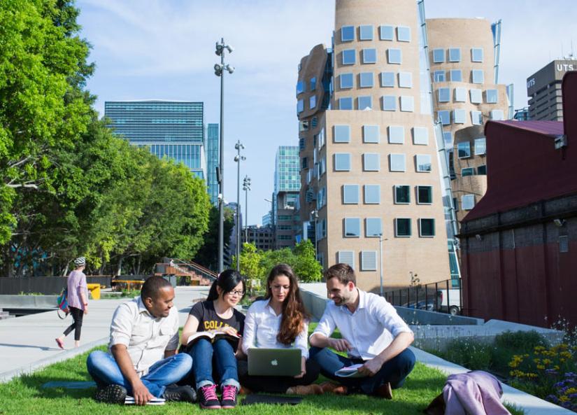 UTS International students seated in front of Dr Chau Chak Wing Building