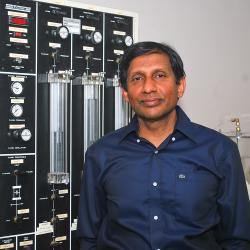 Portait of Professor Buddhima Indraratna standing in front of some equipment