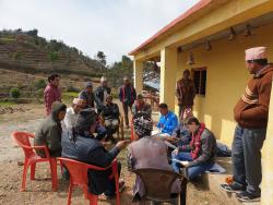 People sitting around a house in rural village