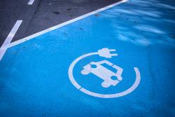 Electric vehicle charging symbol on road