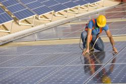 Worker positioning solar panels