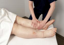 Clinician examining patient legs